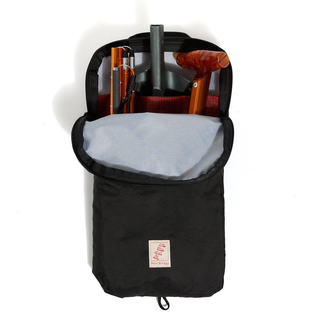 Black backpack with interior compartments and a visible brand logo on a white background