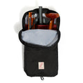 Black backpack with interior compartments and a visible brand logo on a white background
